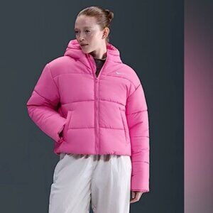 Nike Women's Therma-FIT Hooded Puffer Jacket in bright pink. Medium